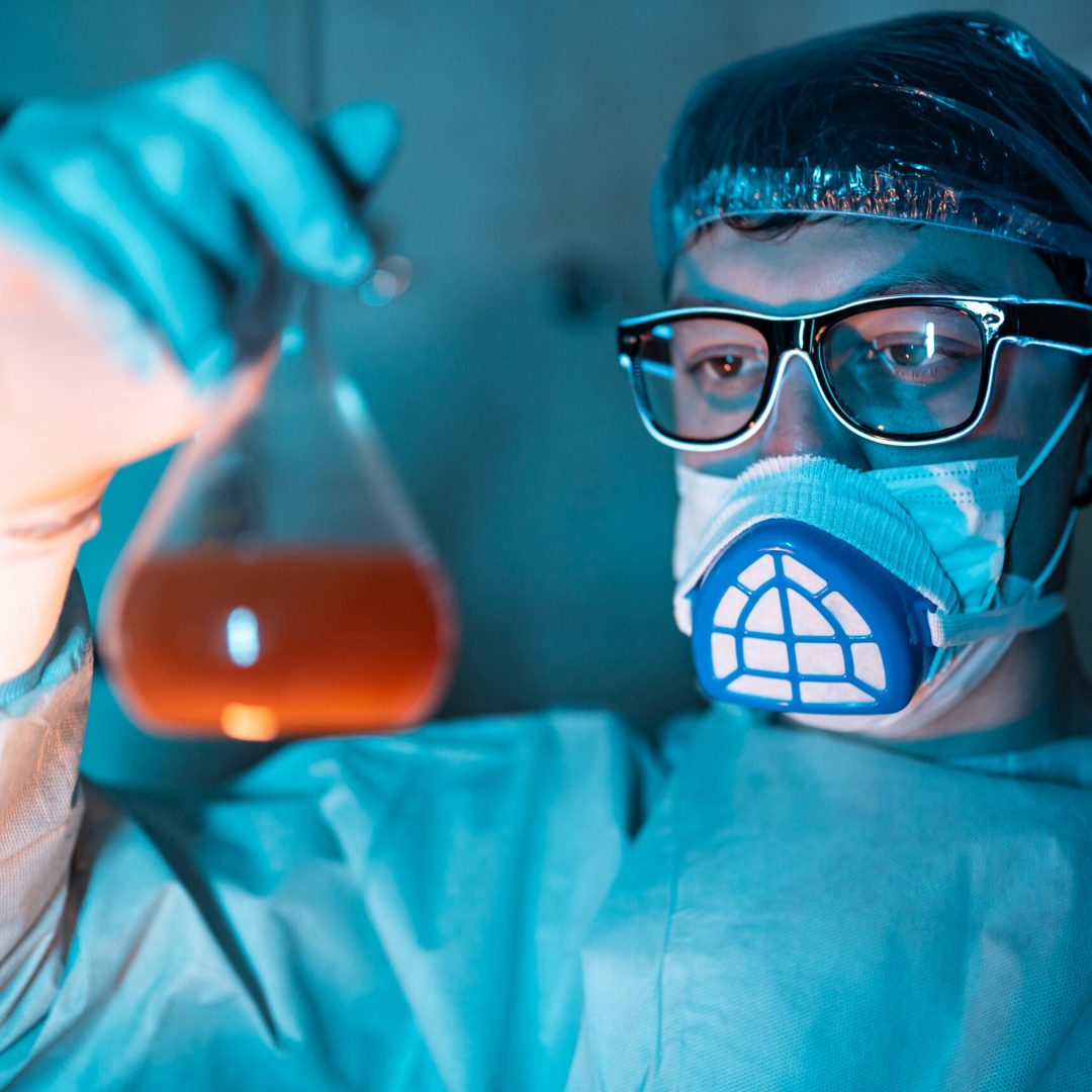 Young male researcher carrying out scientific researcher, working at laboratory.